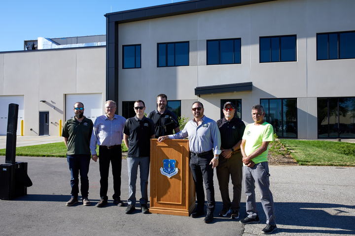 a group of men standing in front of a building