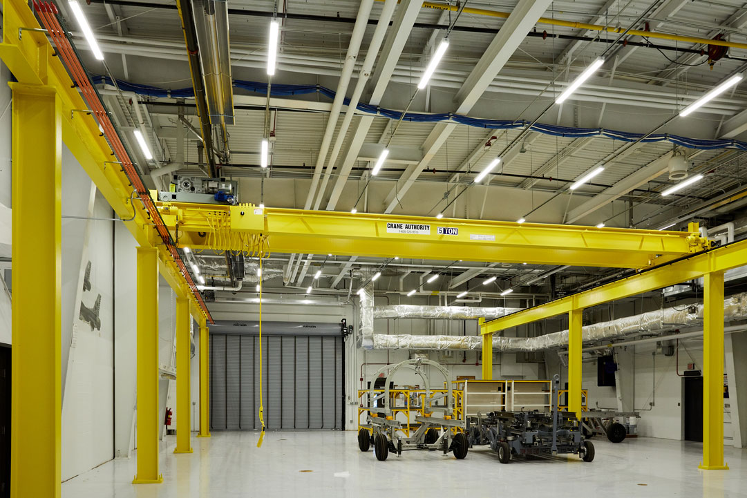 a large yellow crane in a factory