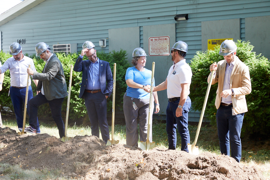 a group of people wearing helmets and shovels