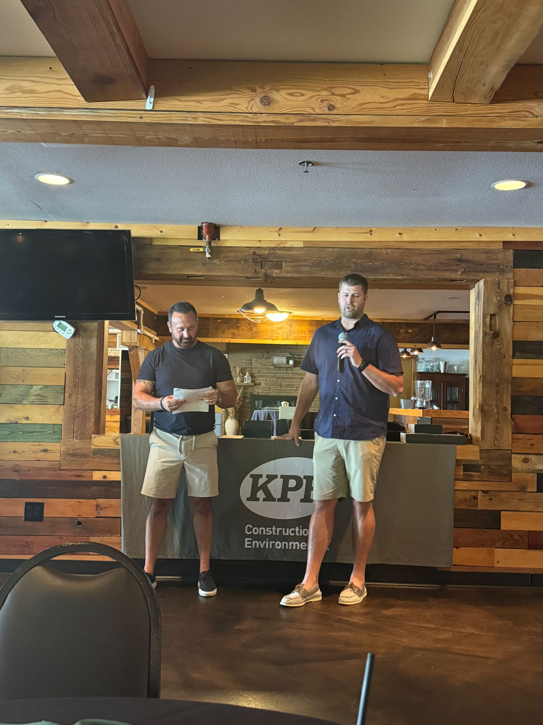 two men standing on a stage