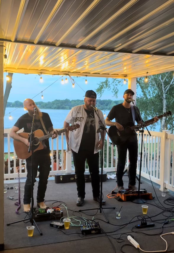 a group of men playing instruments on a porch