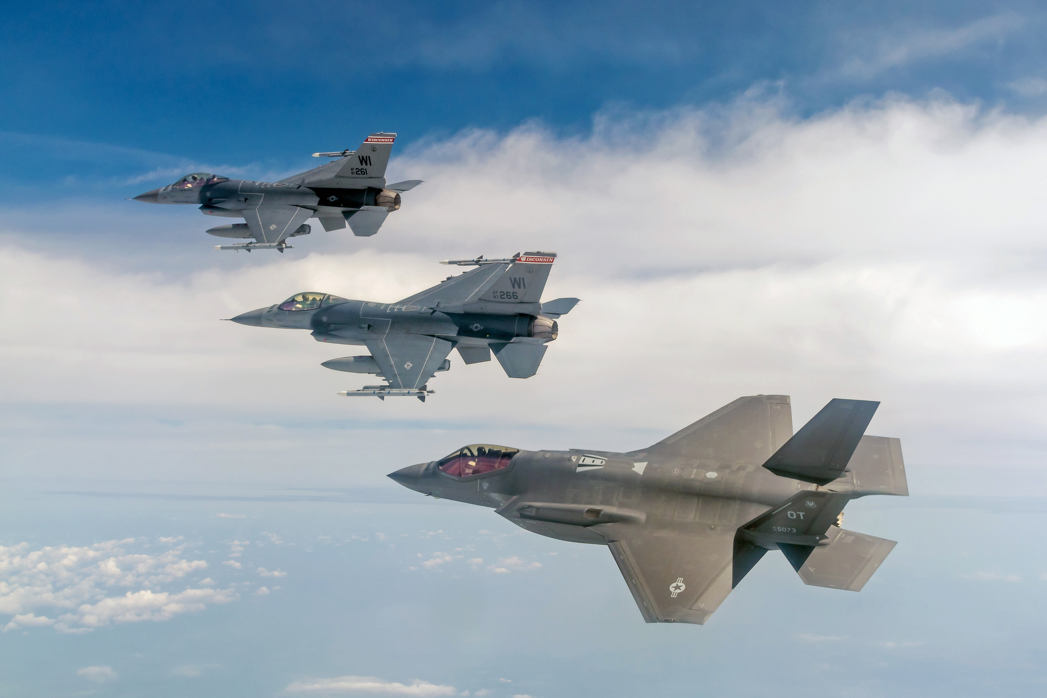 a group of fighter jets flying in the sky